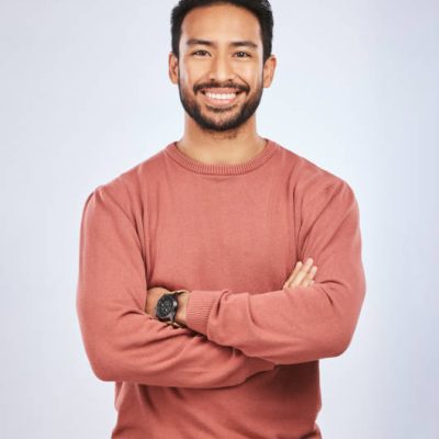 Portrait, happy or confident Asian man with arms crossed or smile in studio in casual fashion or clothes. Relax, satisfied or friendly handsome person smiling on white background with pride or joy